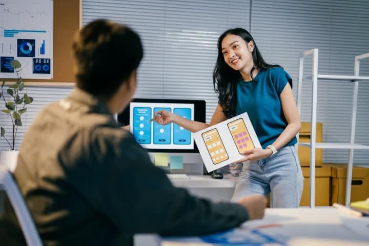 UI/UX designers working on label artwork